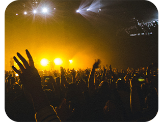 crowded people at a concert image with yellow lights