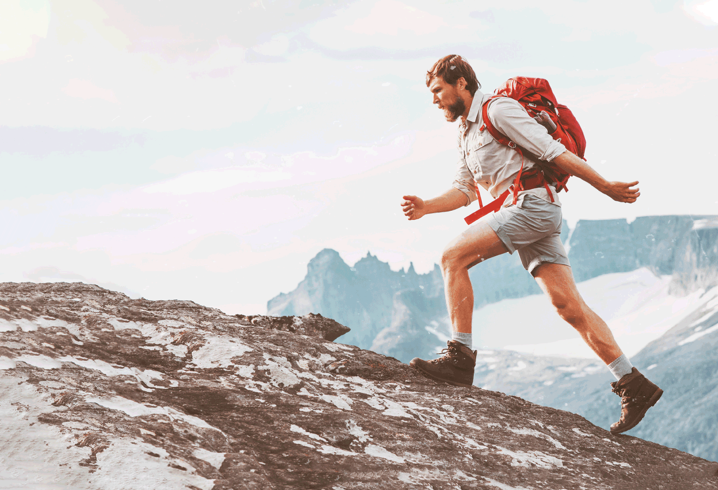 man with a backpack climbing mountains